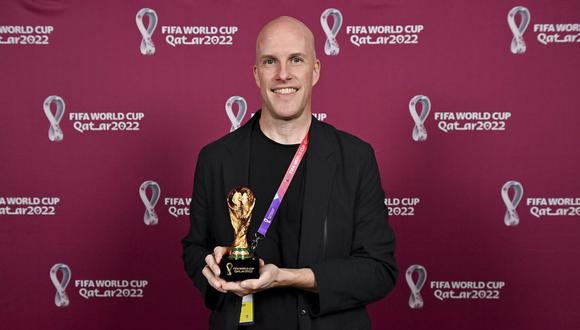 Grant Wahl smiles as he holds a World Cup replica trophy during an award ceremony in Doha, Qatar on Nov. 29, 2022. Wahl, one of the most well-known soccer writers in the United States, died early Saturday Dec. 10, 2022 while covering the World Cup match between Argentina and the Netherlands. (Brendan Moran, FIFA via AP)