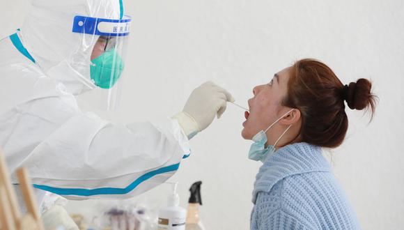 Un residente se somete a una prueba de ácido nucleico para el coronavirus Covid-19 en Hangzhou, en la provincia oriental china de Zhejiang, el 11 de marzo de 2022. (Foto de AFP)