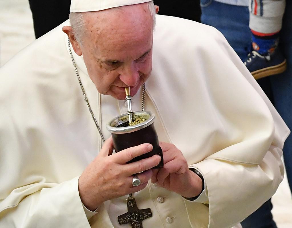 Pope Francis drinks mate, a traditional South American drink, as he meets with Argentinian soldiers from the United Nations during the weekly general audience on January 8, 2020 at Paul-VI hall in the Vatican. (Photo by Andreas SOLARO / AFP)