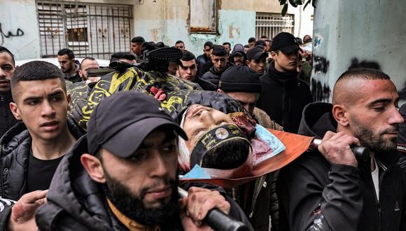 Dolientes llevan el cuerpo de uno de víctimas que estaban entre los tres palestinos que murieron cuando agentes israelíes encubiertos allanaron el hospital Ibn Sina en la ciudad de Jenin, en Cisjordania, el 30 de enero de 2024. (Foto de Zain JAAFAR / AFP)