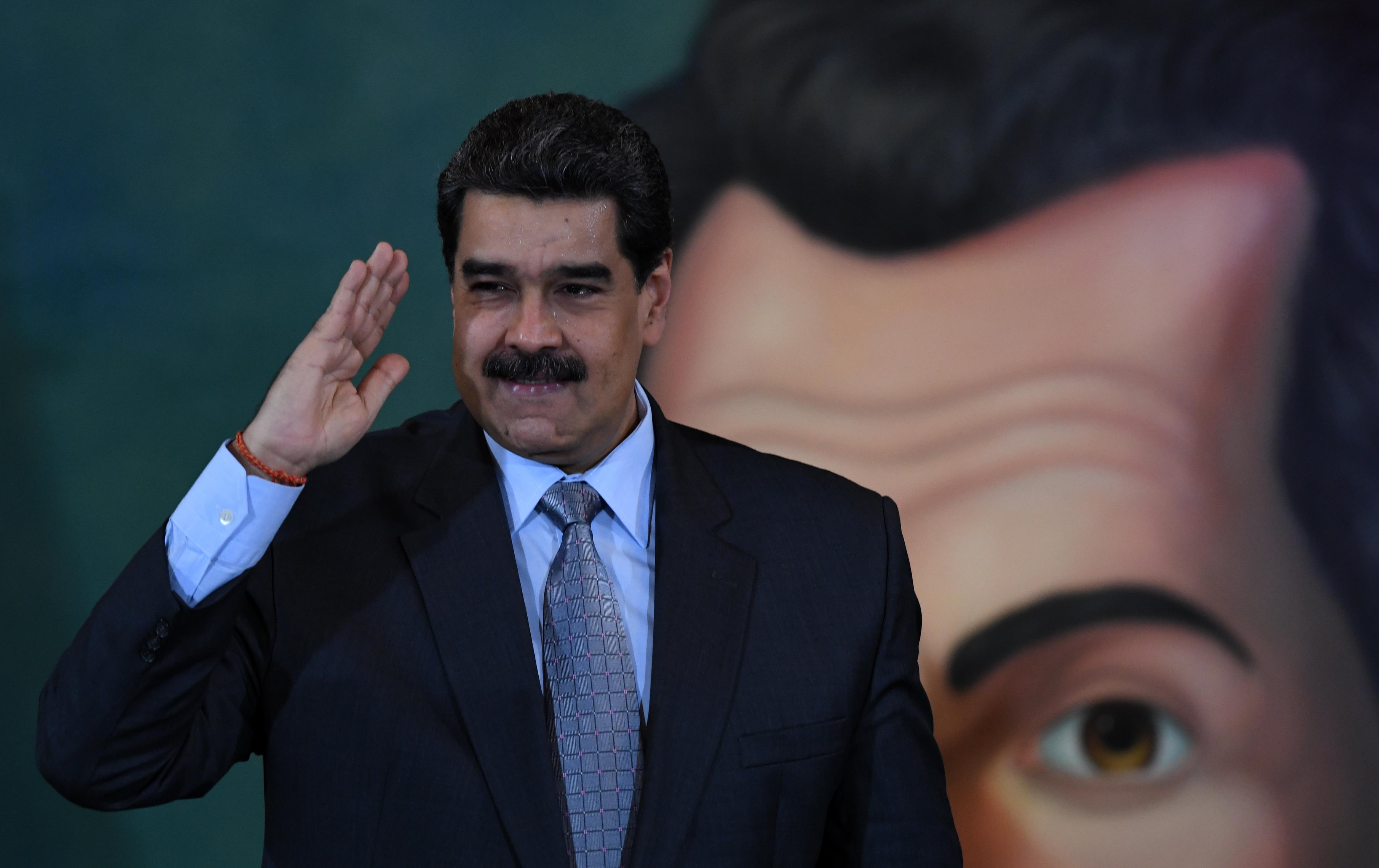 Venezuelan President Nicolas Maduro salutes after a press conference in Caracas on September 30, 2019. - Virtually all countries sent diplomats to the United Nations for the General Assembly last week, but Venezuela was a special case -- it had two delegations, each dueling for recognition. (Photo by YURI CORTEZ / AFP)