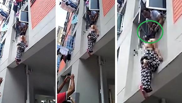 Captan preciso momento en el que hombre agarra del pelo a mujer que caía del tercer piso de edificio (VÍDEO)