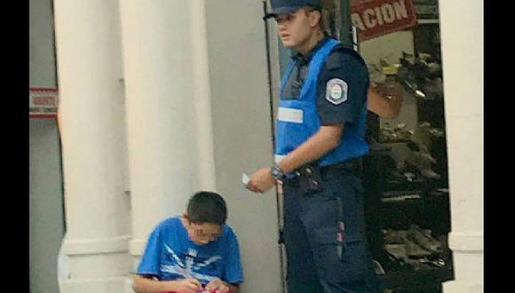 ​Foto de policía ayudando a niño a estudiar en la calle se hace viral en Facebook