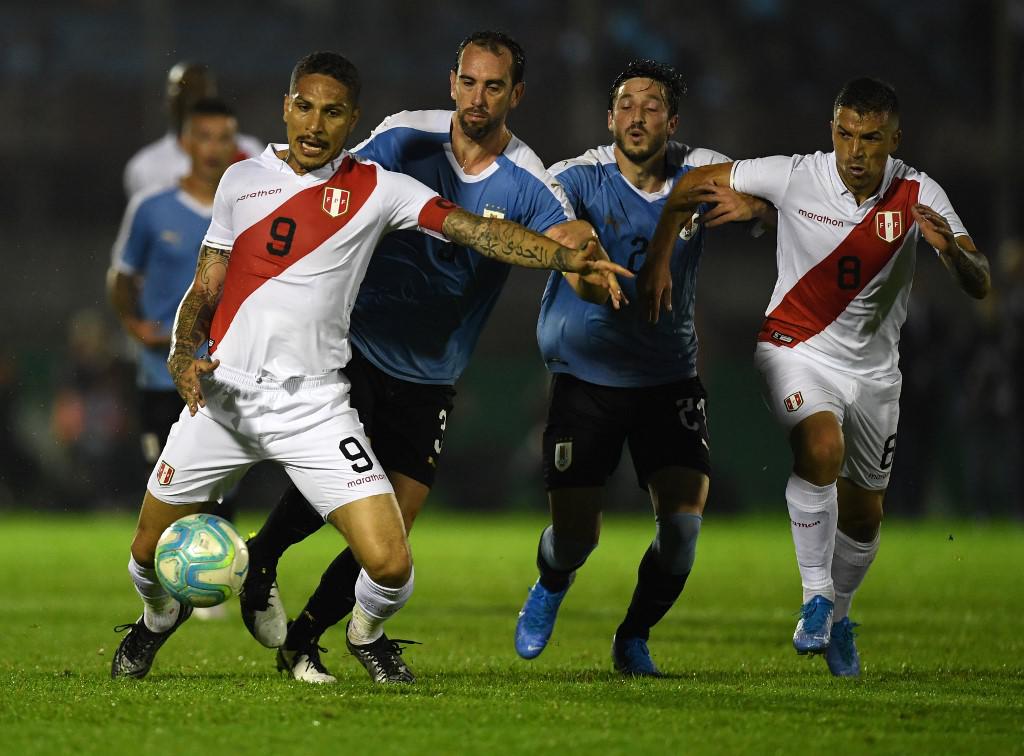 Peru's forward Paolo Guerrero (L) controls the ball under the pressure of Uruguay's Diego Godin (2-L) during an international friendly football match in Montevideo on October 11, 2019. (Photo by EITAN ABRAMOVICH / AFP)