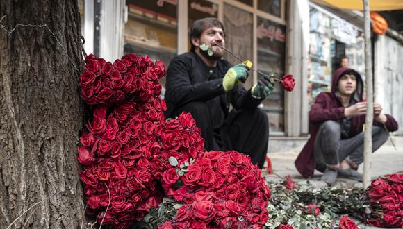 Los vendedores afganos que venden rosas esperan a los clientes a lo largo de la calle de las flores con motivo del Día de San Valentín en el área de Shar-e-Naw de Kabul el 14 de febrero de 2023. (Foto de Wakil KOHSAR / AFP)