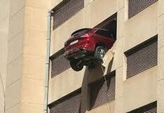Mujer da marcha atrás con su auto que rompe pared y queda suspendido en edificio
