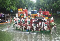 Chinitos reman en impresionantes botes con cabezas de dragones durante festival