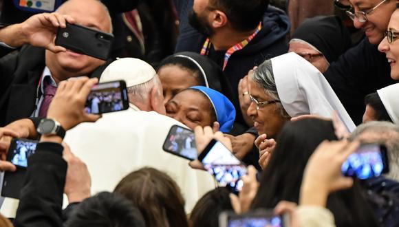 Pope Francis kisses a nun who had been shouting "Long live the pope!" as he arrives for the weekly general audience on January 8, 2020 at Paul-VI hall in the Vatican. - Pope Francis warned a nun not to bite him Wednesday in a joking reference to his run-in with an overly zealous pilgrim last week which saw him slap the woman's hand. "I'll give you a kiss, but you must stay calm. Don't bite!" he told the enthusiastic nun, who had been shouting "Long live the pope!" as Francis greeted pilgrims before his weekly general audience. (Photo by Andreas SOLARO / AFP)
